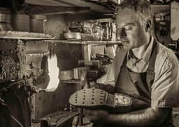 Isaac Jackman shoe repairs logo