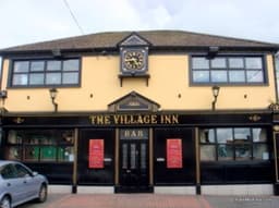 The Village Inn logo